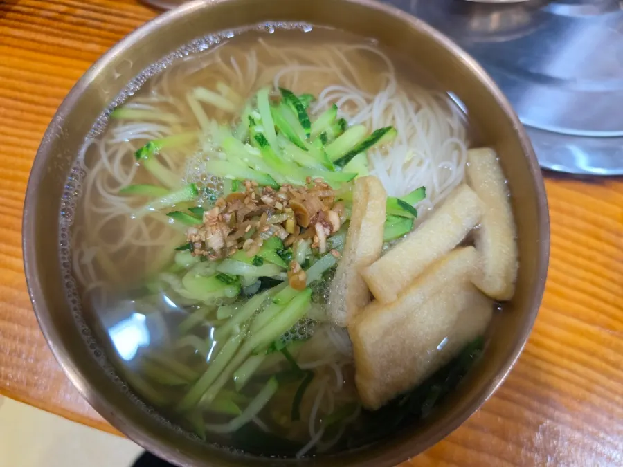 Janchi guksu topped with fried tofu, zucchini, and chives