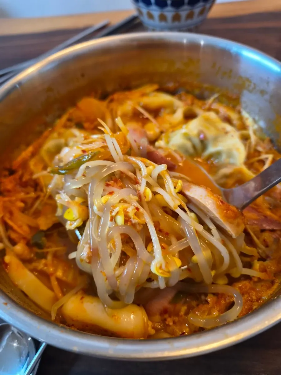 Budae jjigae with cheese and sweet potato rice cake sari added