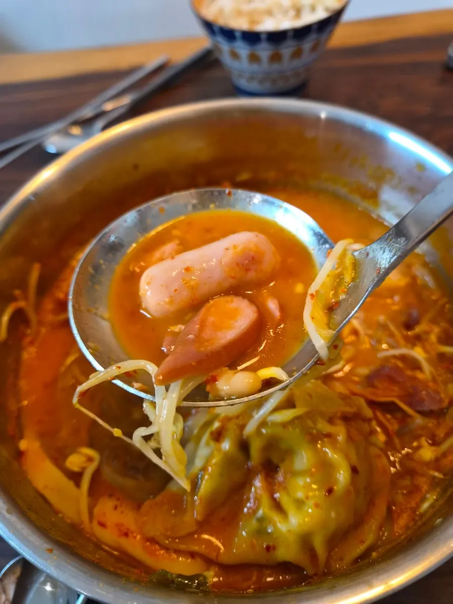 A home meal spread of budae jjigae with rice