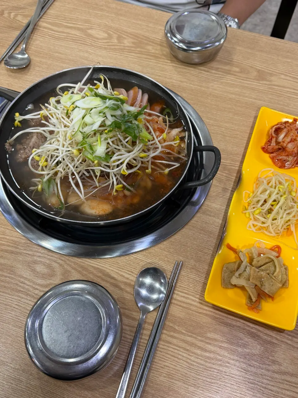 Budae jjigae for two, filled with ingredients before boiling