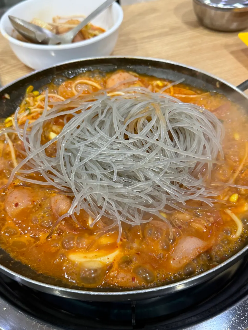 Budae jjigae with added glass noodle and ramen sari
