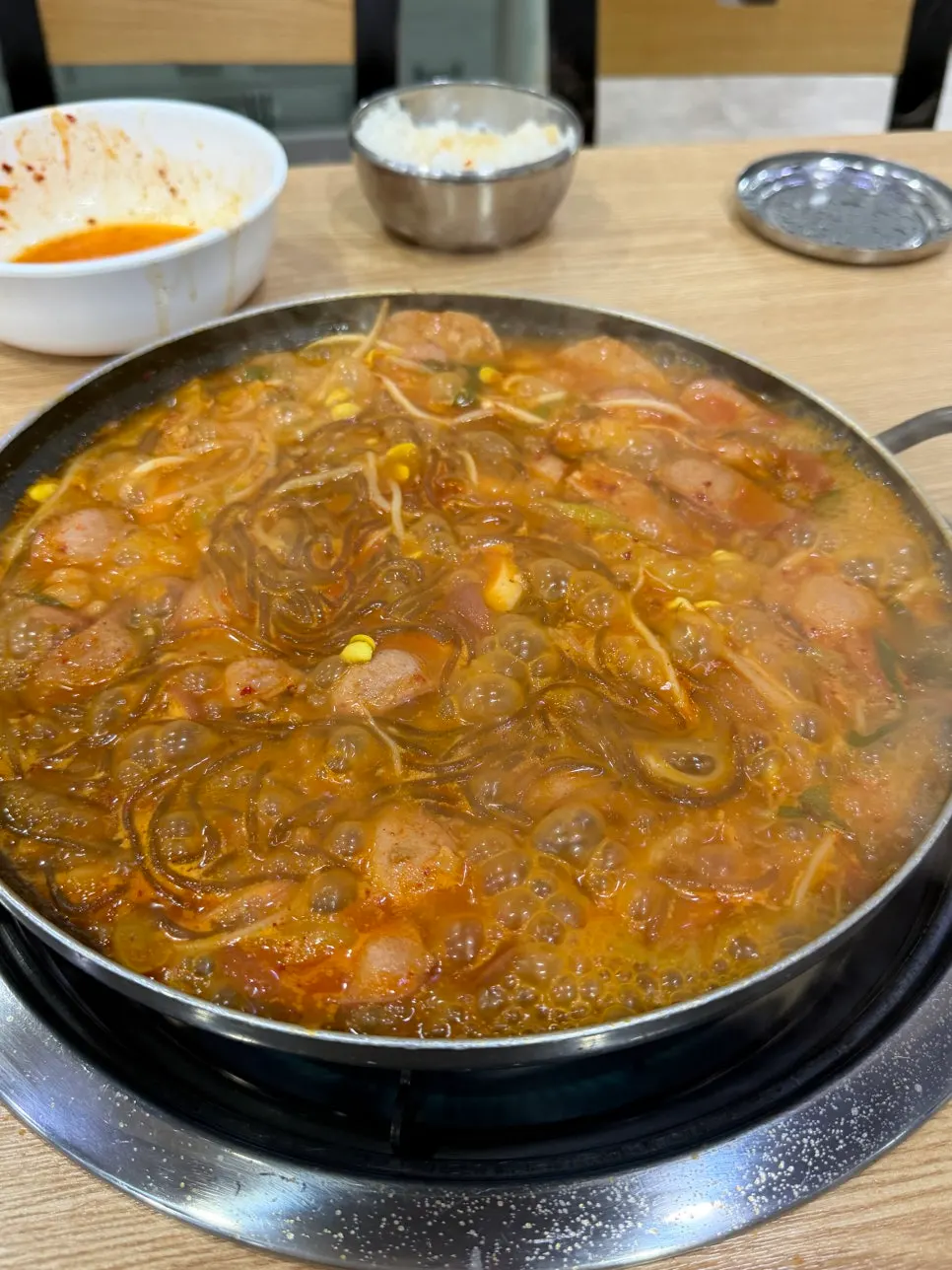 Budae jjigae broth served with a bowl of rice