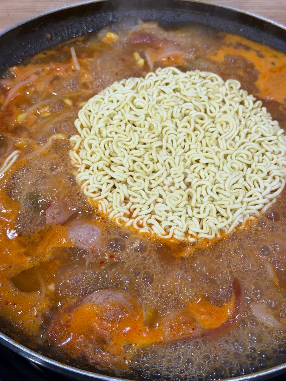 Pot of budae jjigae after broth was topped up
