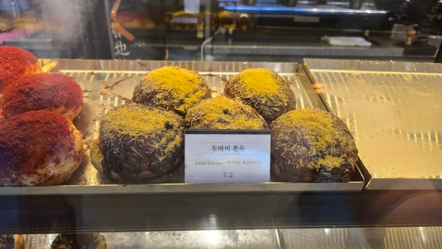 Showcase with various types of Heuksadang doughnuts