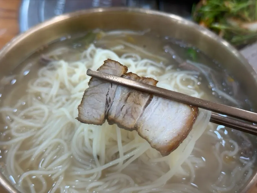 Eating doenjang guksu with side dishes