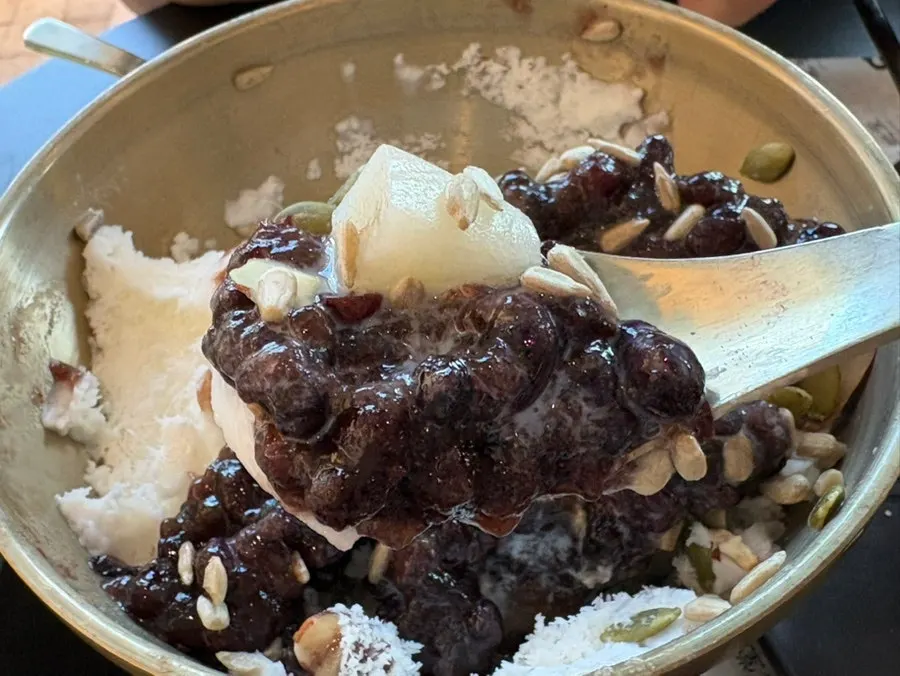 A spoonful of patbingsu topped with nuts