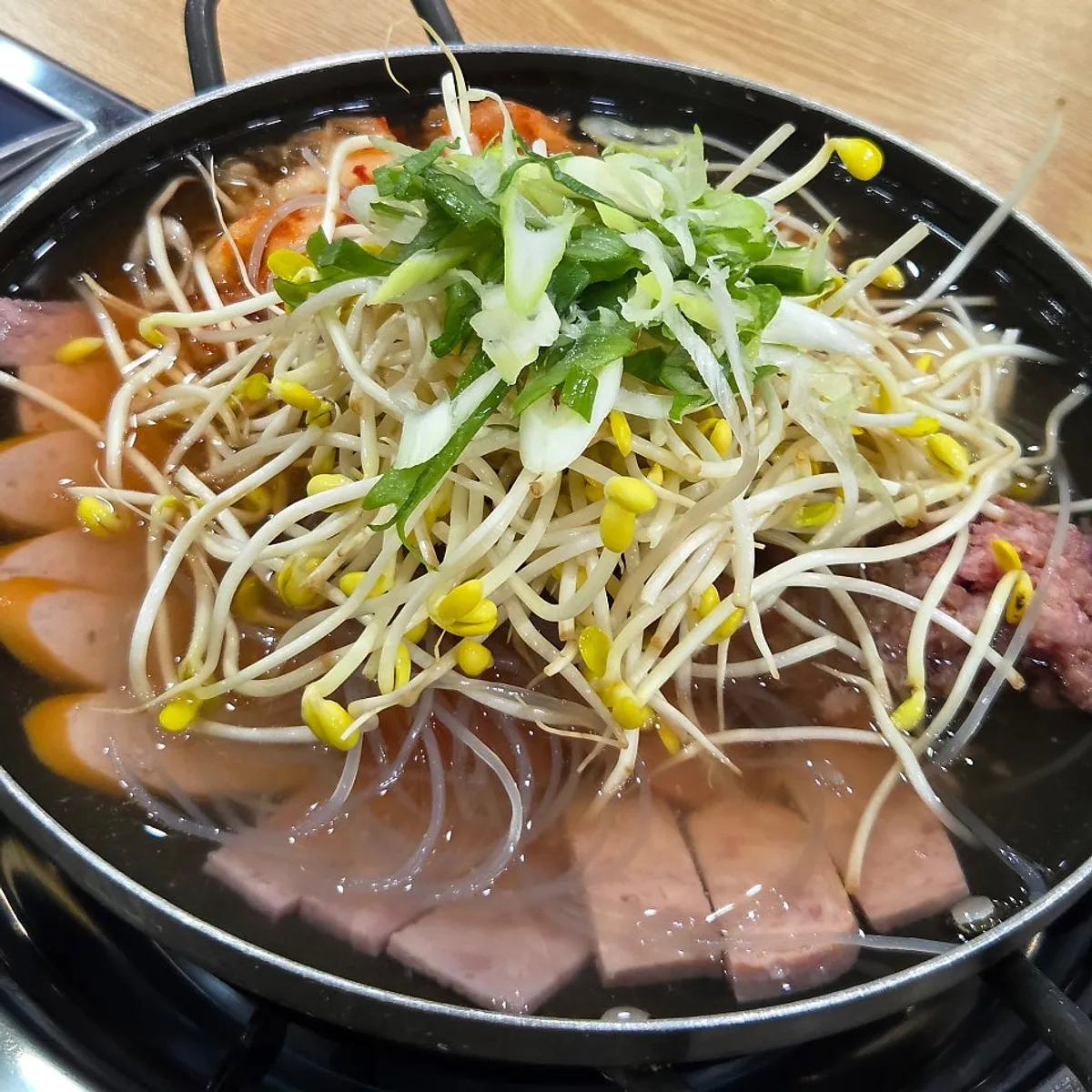 Pot of traditional budae jjigae loaded with ingredients