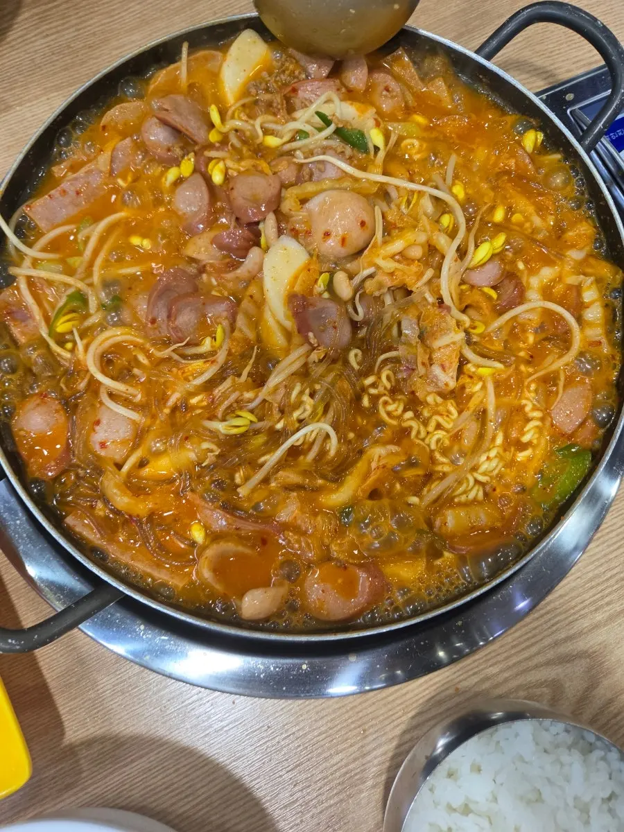 Close-up of the bubbling budae jjigae broth