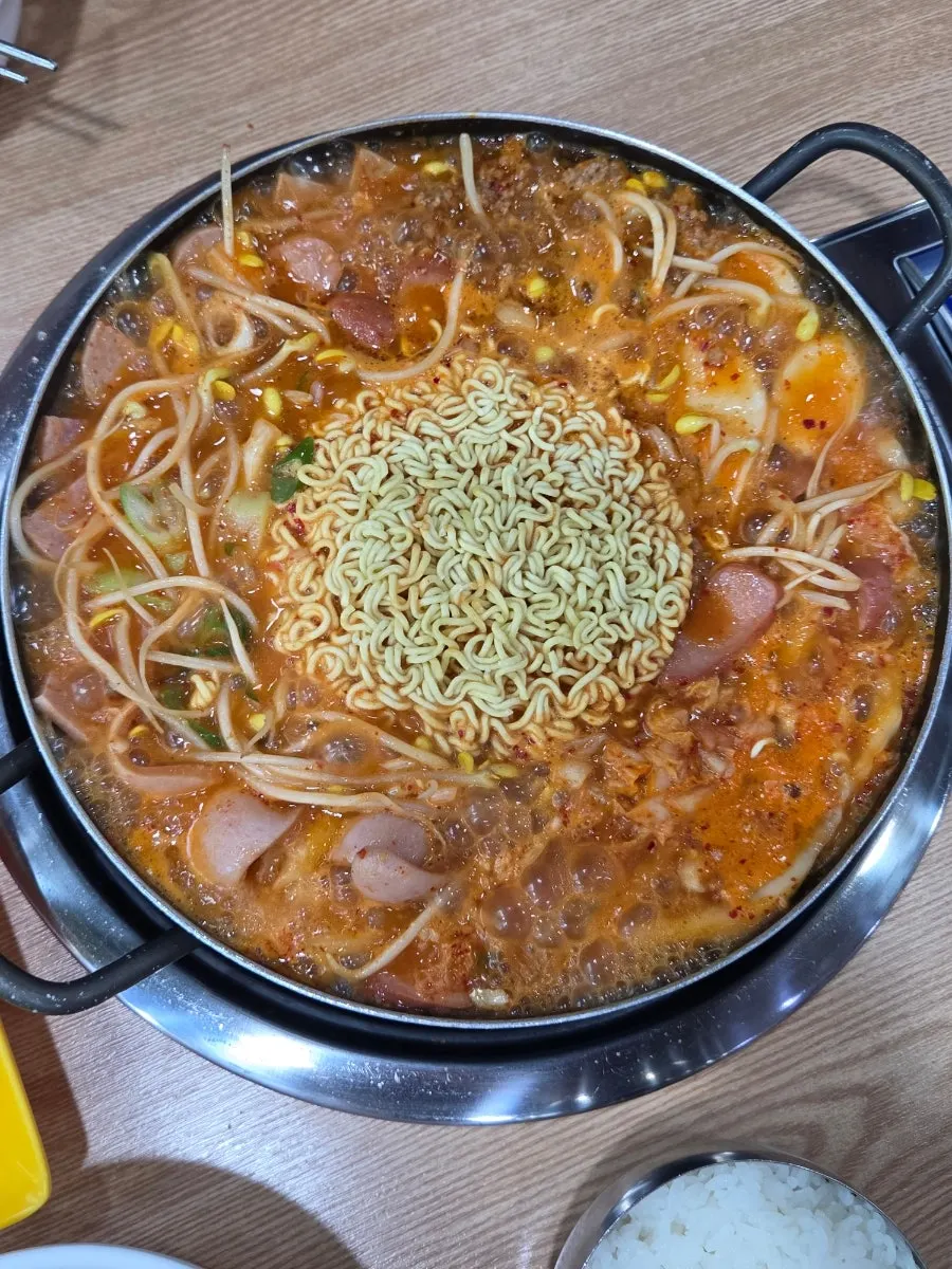 A spoonful of budae jjigae mixed with rice