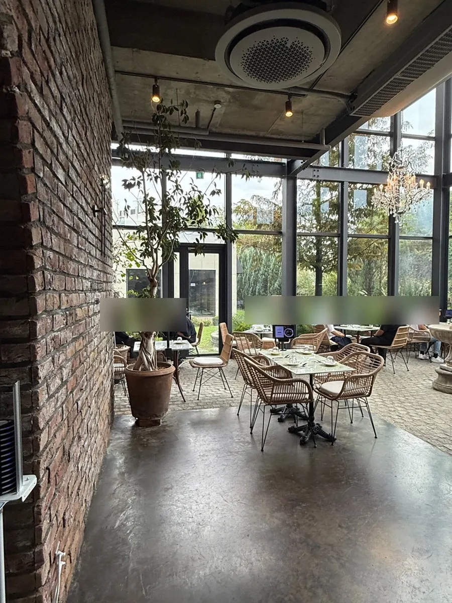 1st-floor greenhouse seating with chandeliers and plants