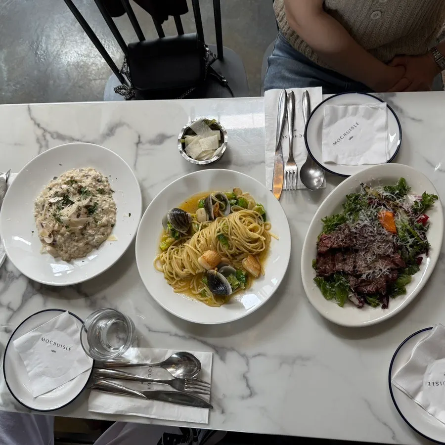 Table spread with pasta, risotto and salad