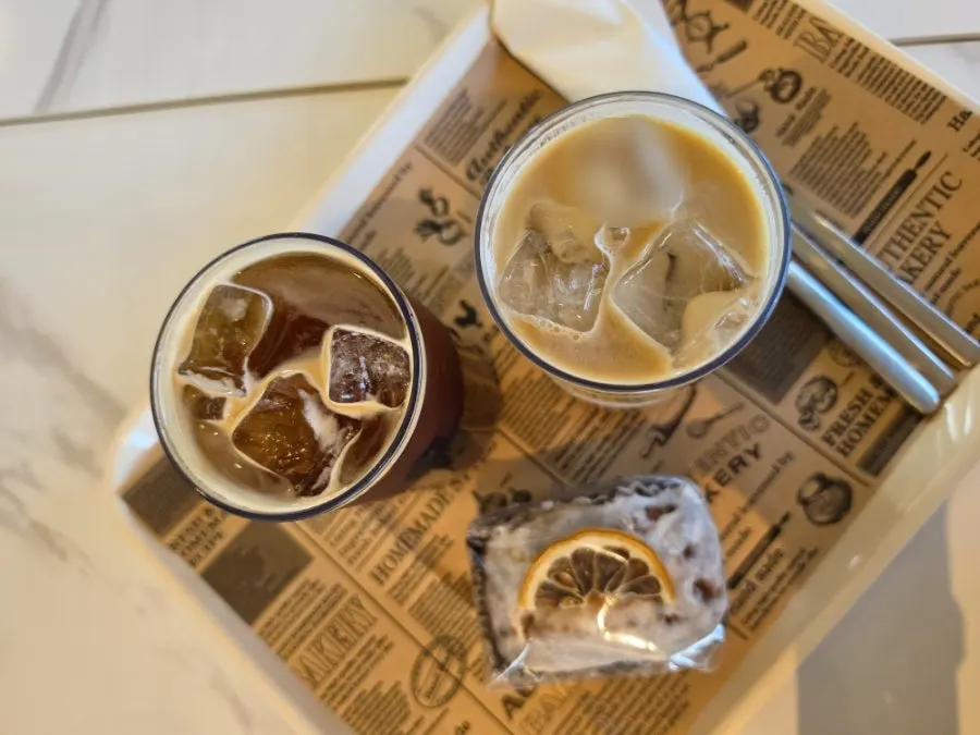Condensed milk latte and dessert on a brown-toned table