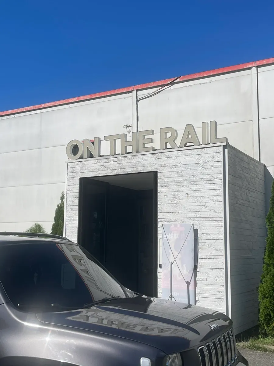 On the Rail café entrance with railway tracks running past it