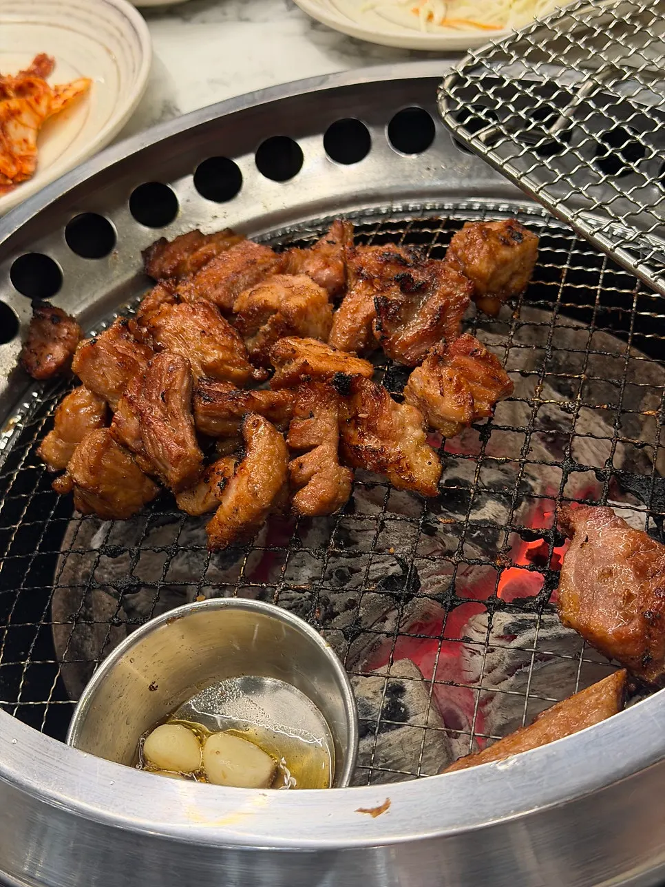 집게로 집어 든 양념구이 한 점
