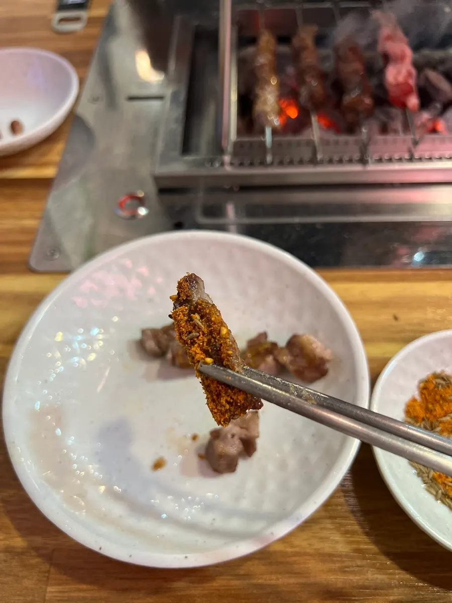 Close-up of well-grilled lamb skewers