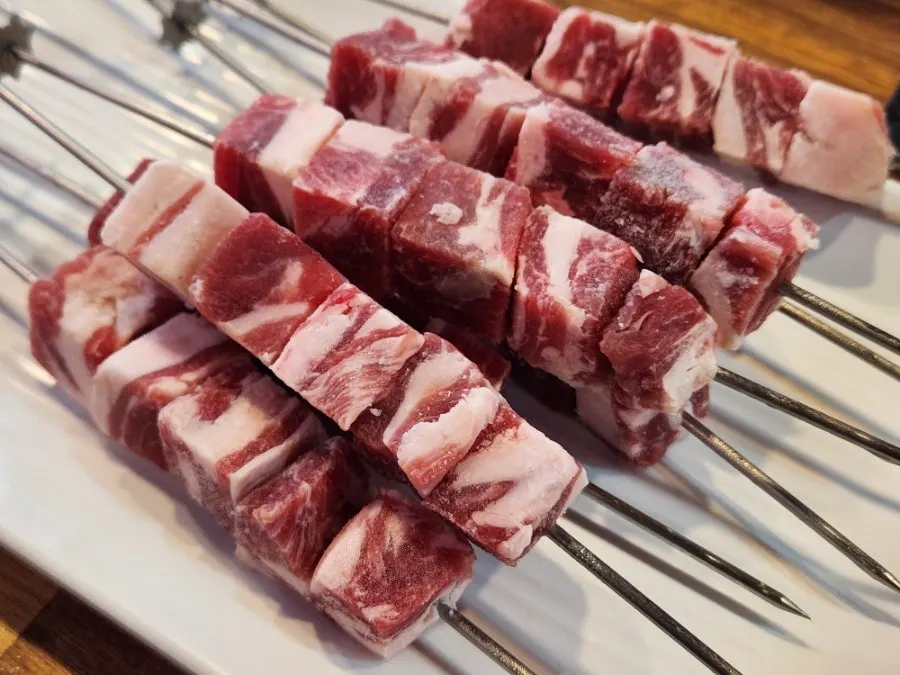 Lamb skewers placed on the charcoal grill