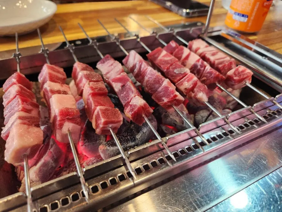 Lamb skewers turning golden brown