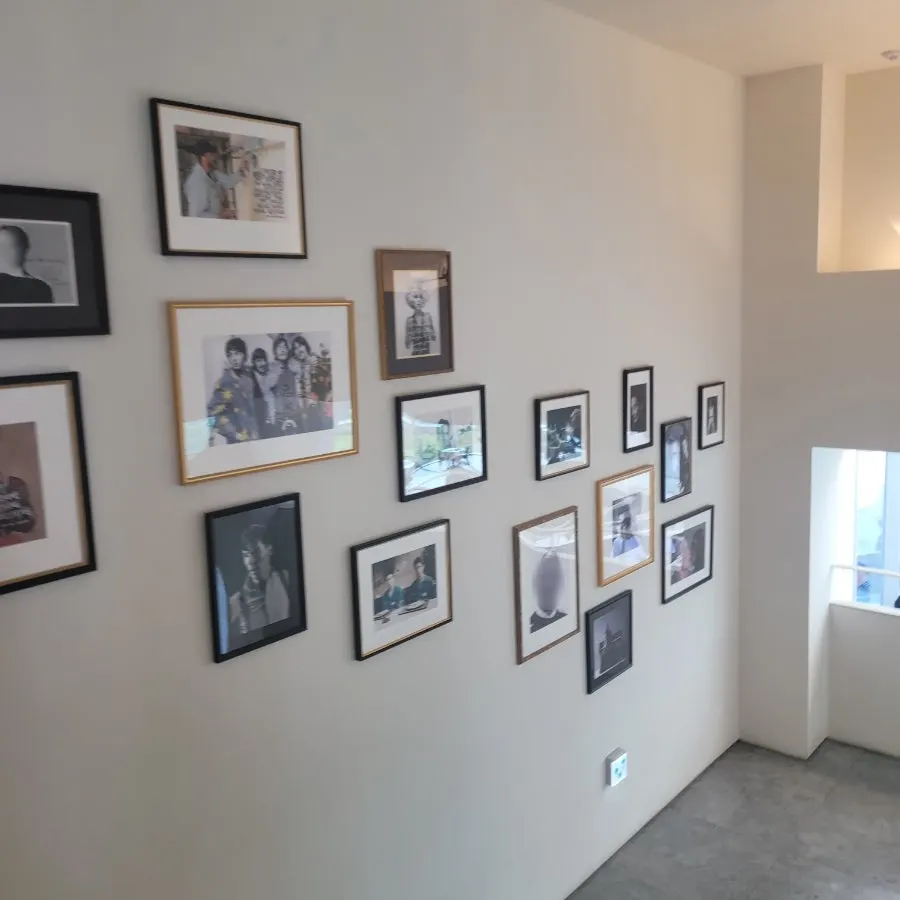 Framed pictures hung along the stairwell wall