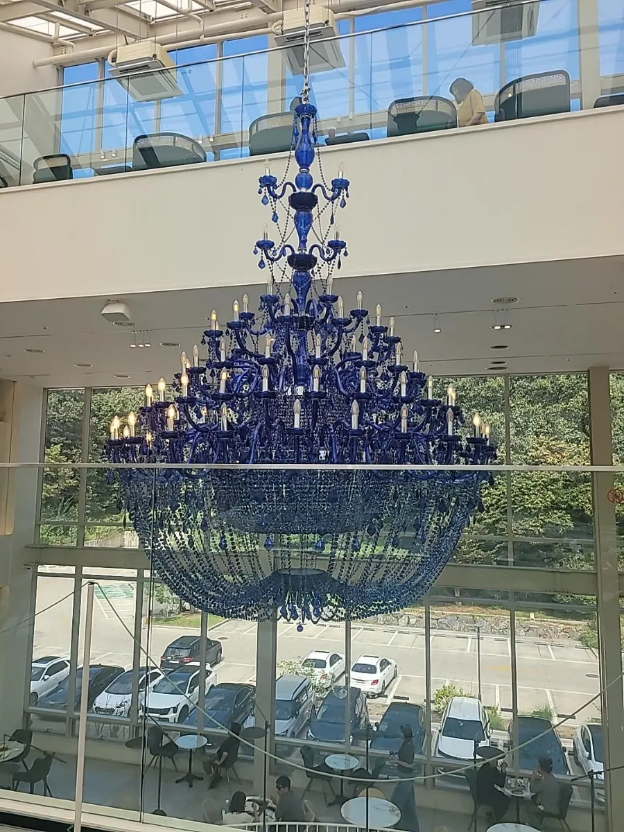 Vertical shot of the large chandelier inside the café