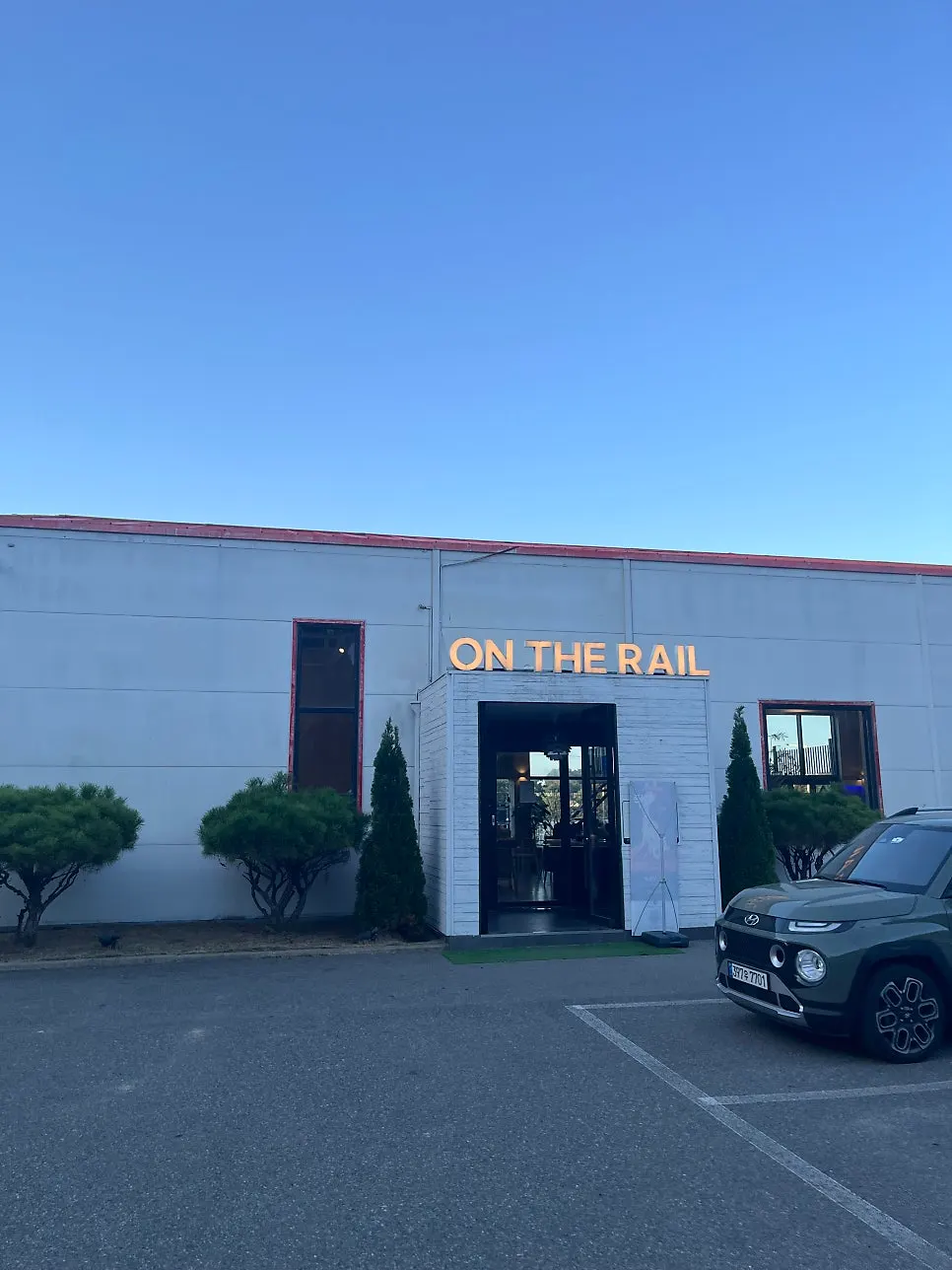 Exterior of On the Rail café with a large parking area