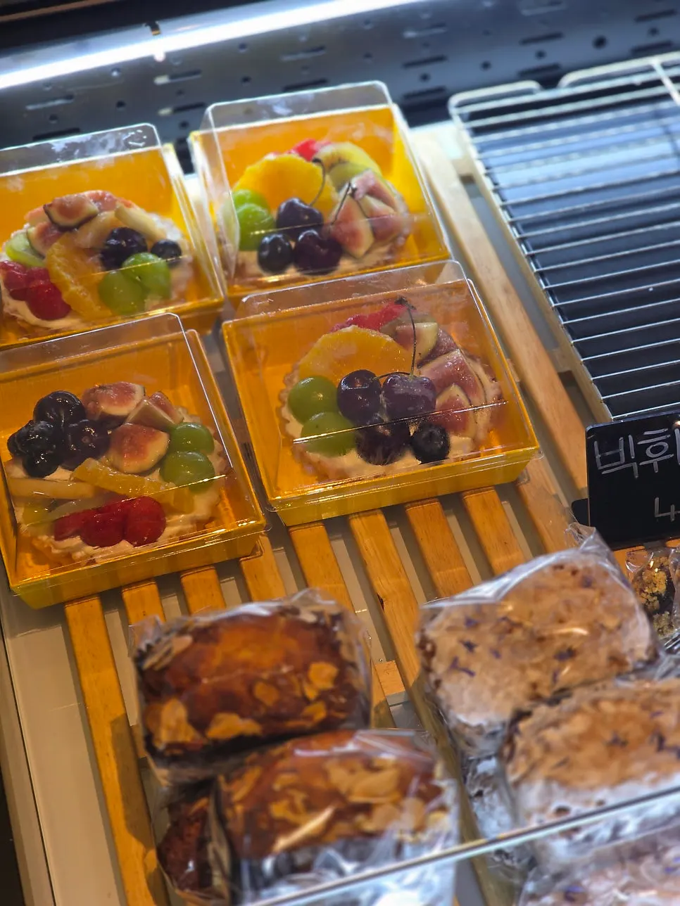 Fruit tart and custard cream bread on the display shelf