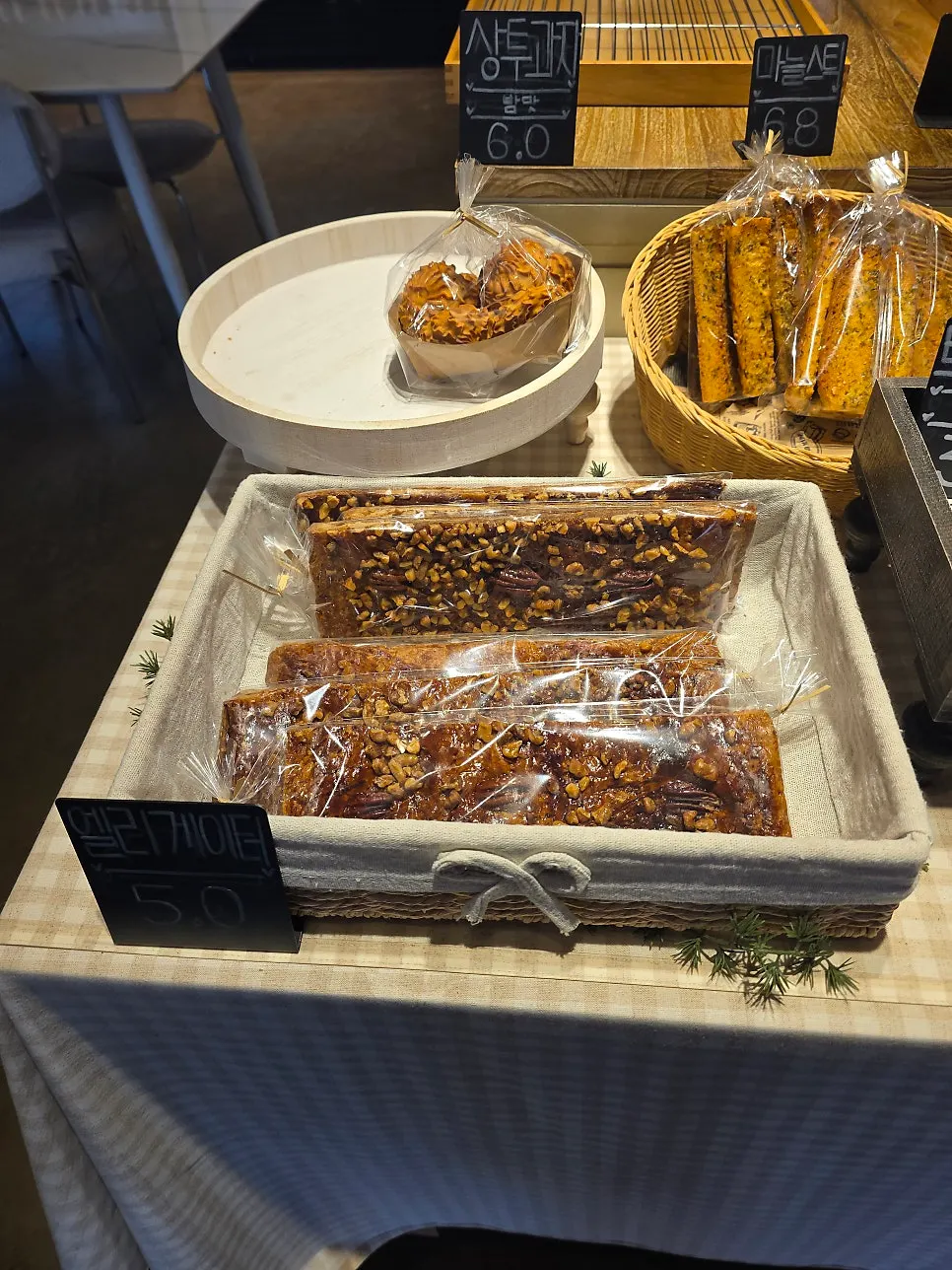 Topknot cookies and garlic sticks and other baked snacks on display