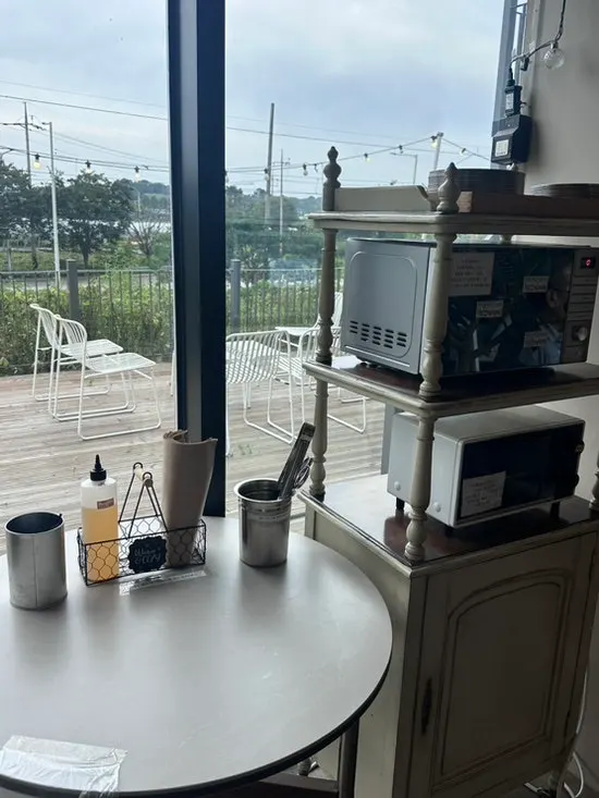 Interior of On the Rail with floor-to-ceiling windows and a large teddy bear doll