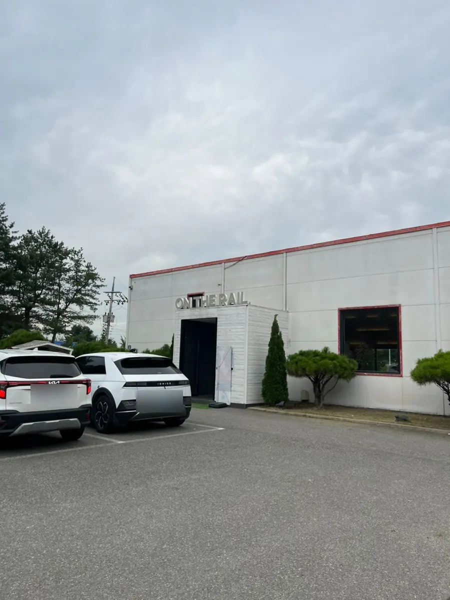 Entrance and spacious parking lot at On the Rail café