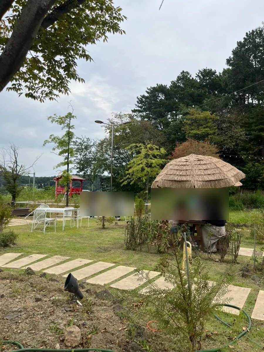 Outdoor tables and green trees at On the Rail