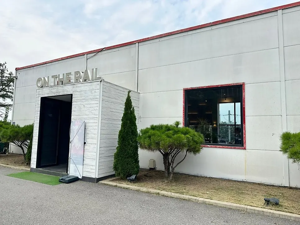 Entrance of On the Rail café with a white-toned, train-station feel