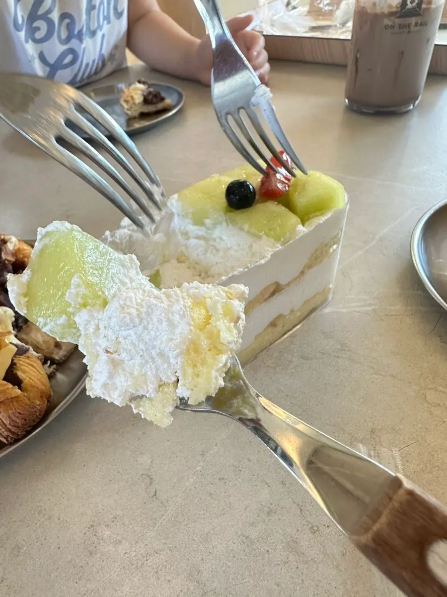 Table with fruit bottle cake and bread