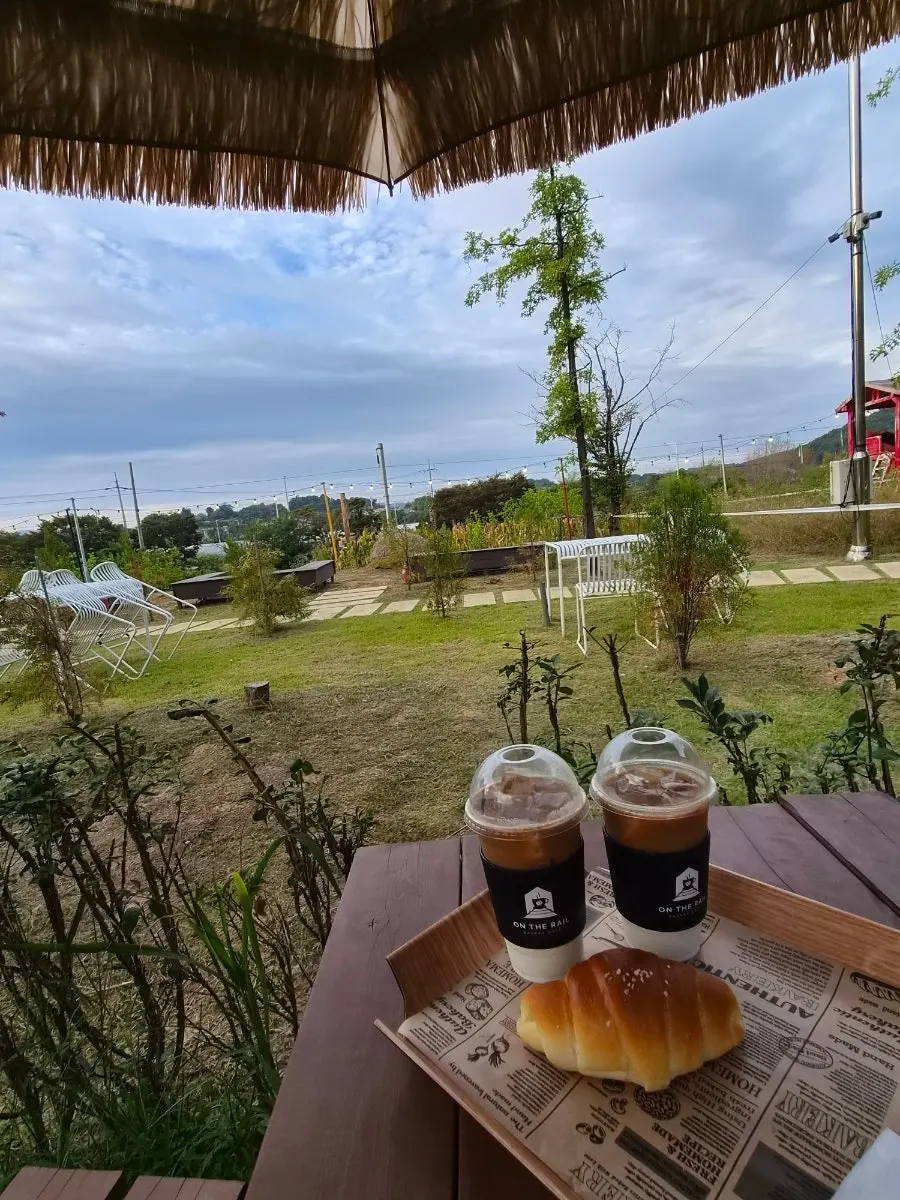 Caffe latte and salt bread on an outdoor table