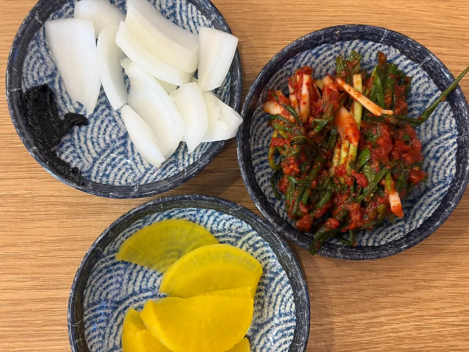 Basic side dishes and green onion kimchi served on a plate