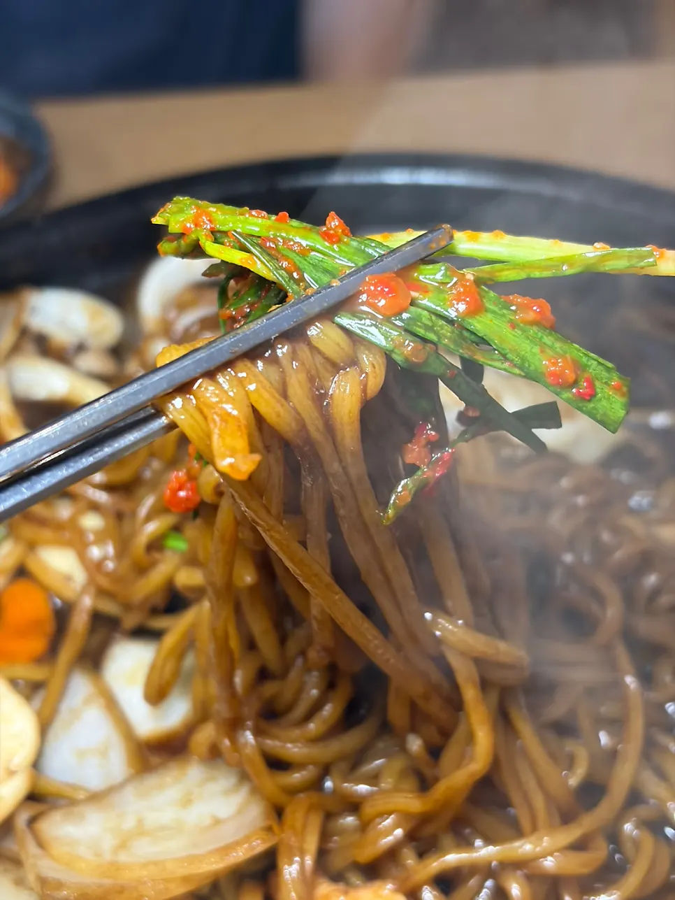 Green onion kimchi placed on top of the stone-plate jajangmyeon noodles