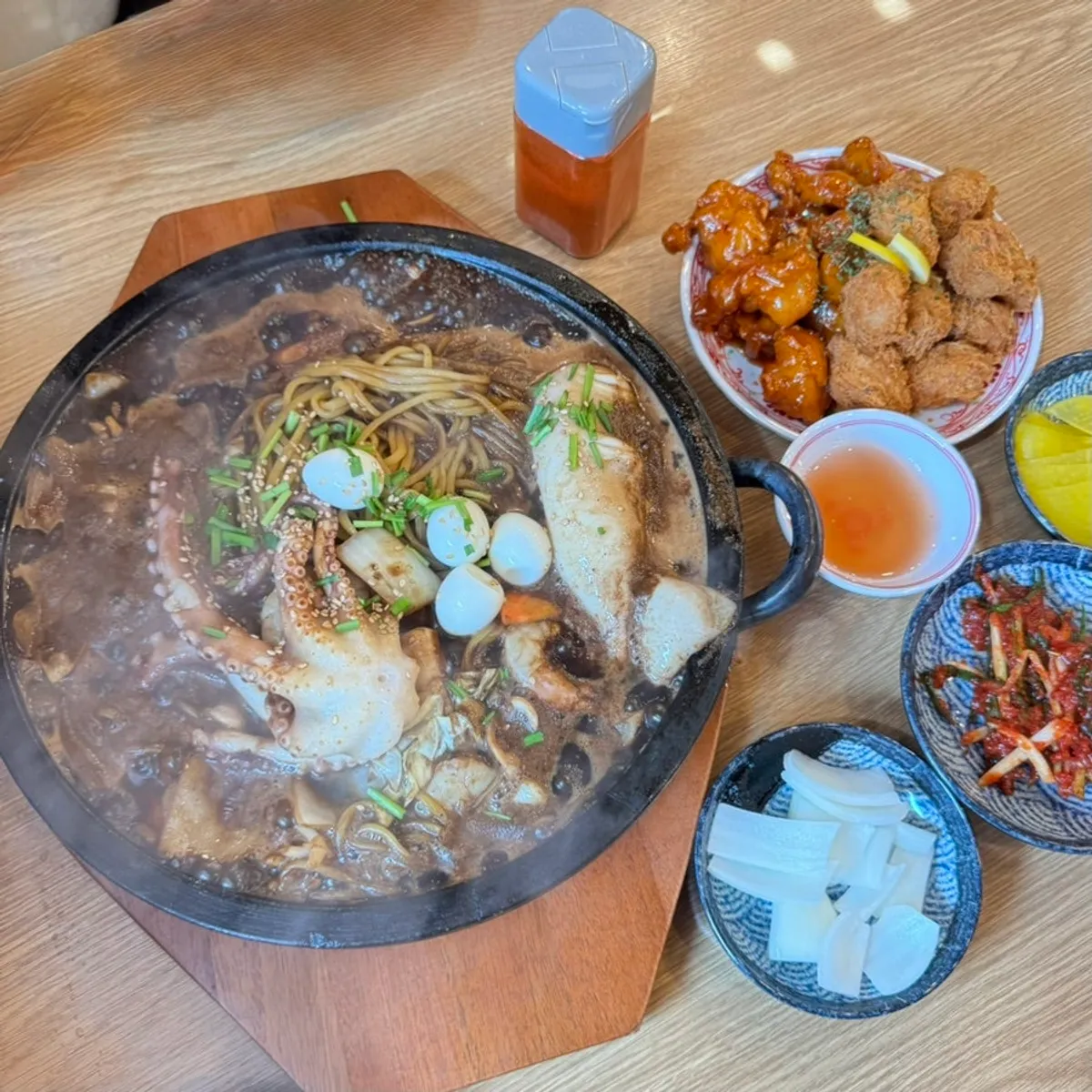 Basic side dishes of onion and pickled radish, plus self-serve green onion kimchi