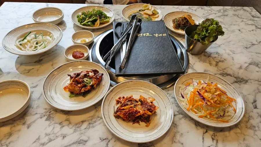 Table of side dishes pre-set after reservation at Jeongwon Galbi