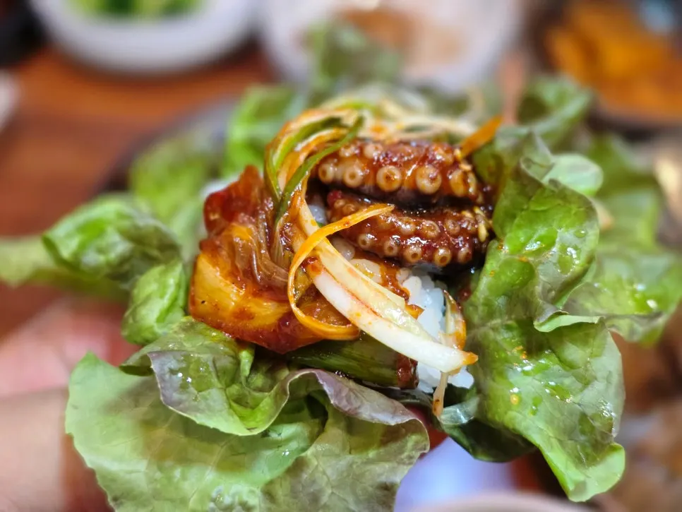 Lettuce wrap with rice, octopus, and scallion shreds