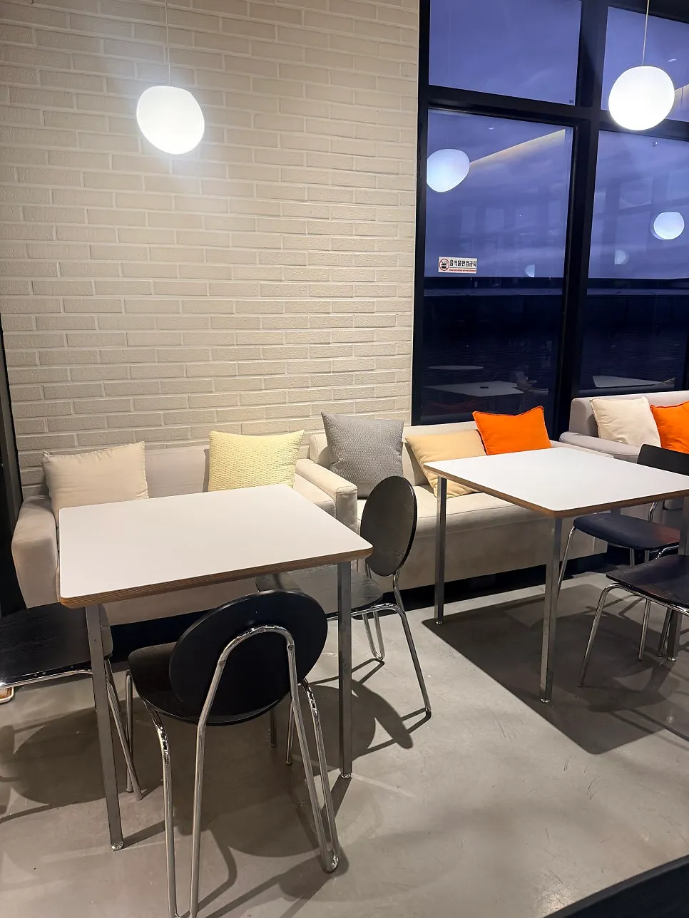 Café seating by a large window at Fruit Forest