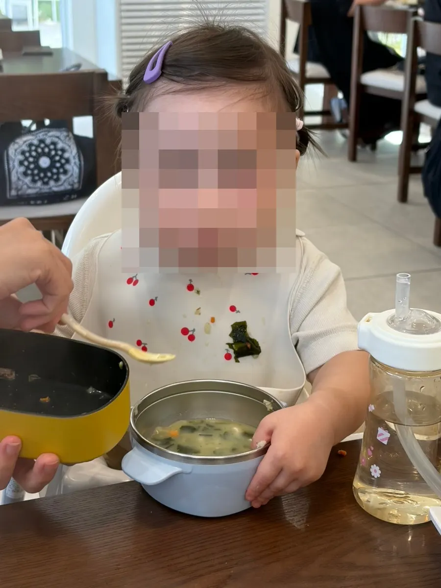 Our baby eating with kids' dishware