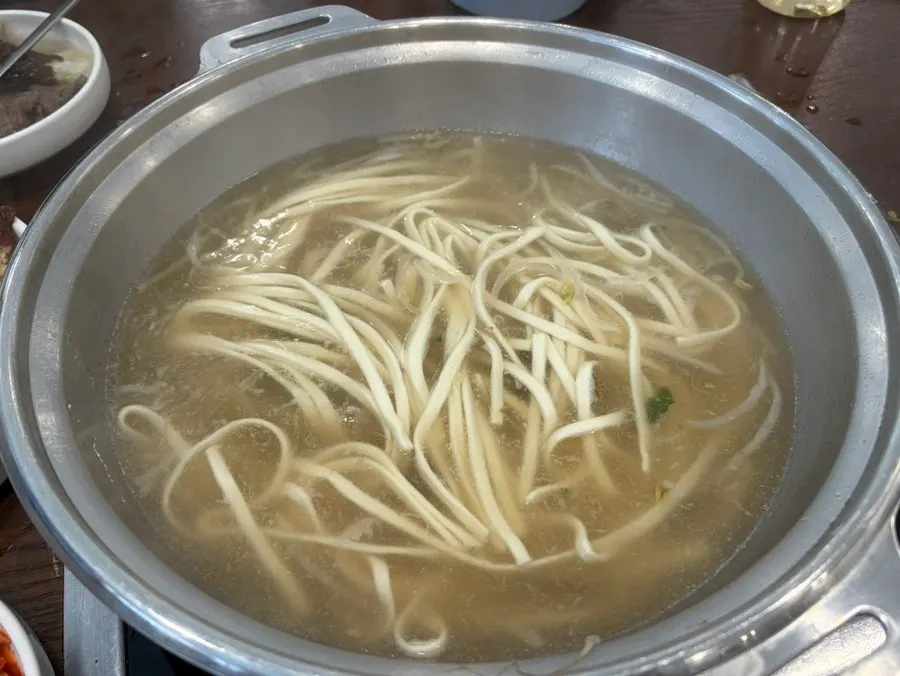 Noodles added and boiled in the leftover hot pot broth