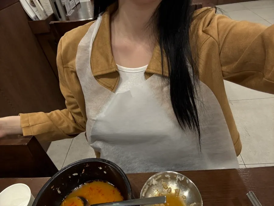 Wearing an apron inside the white and wood-toned restaurant