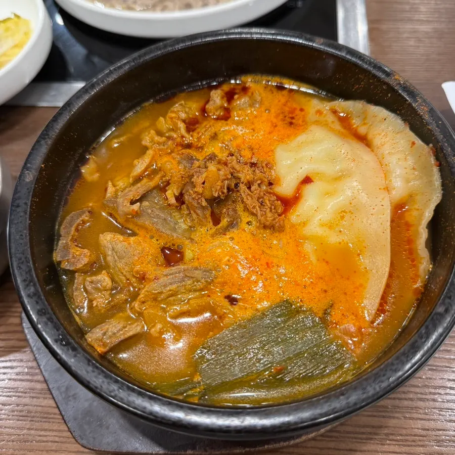 A bowl of spicy mandu jjabagi broth