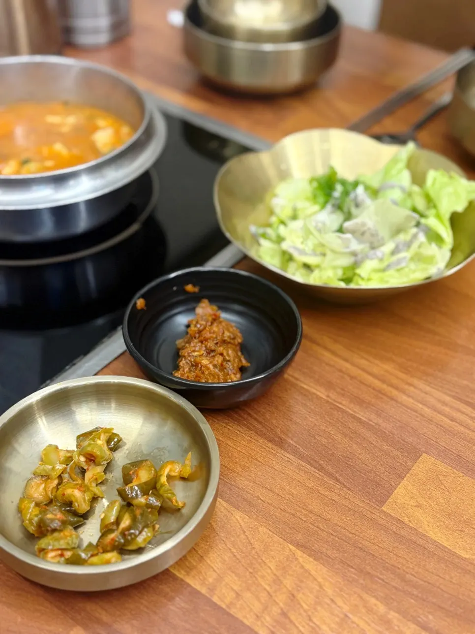 Doenjang stew simmering on the table induction burner