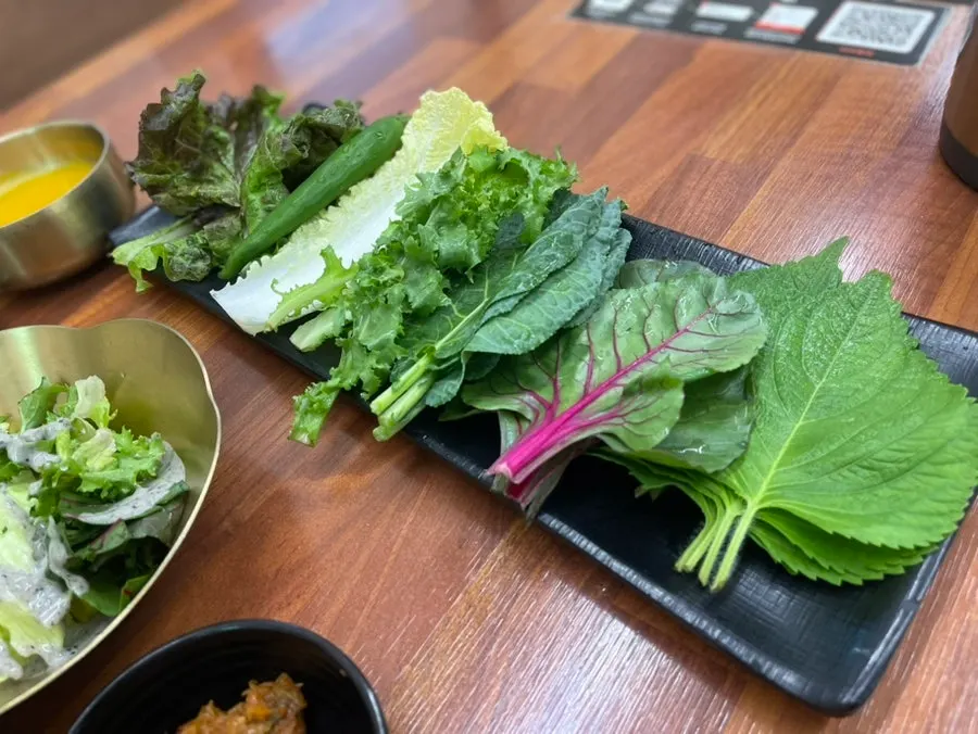 Fresh salad vegetables topped with black sesame dressing