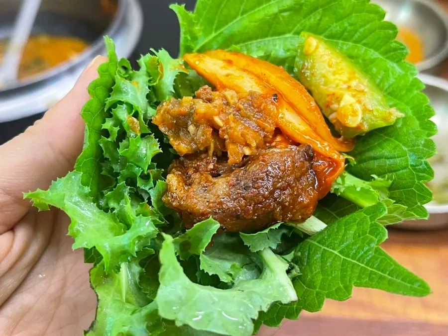 Pork wrapped in red kale as a ssam