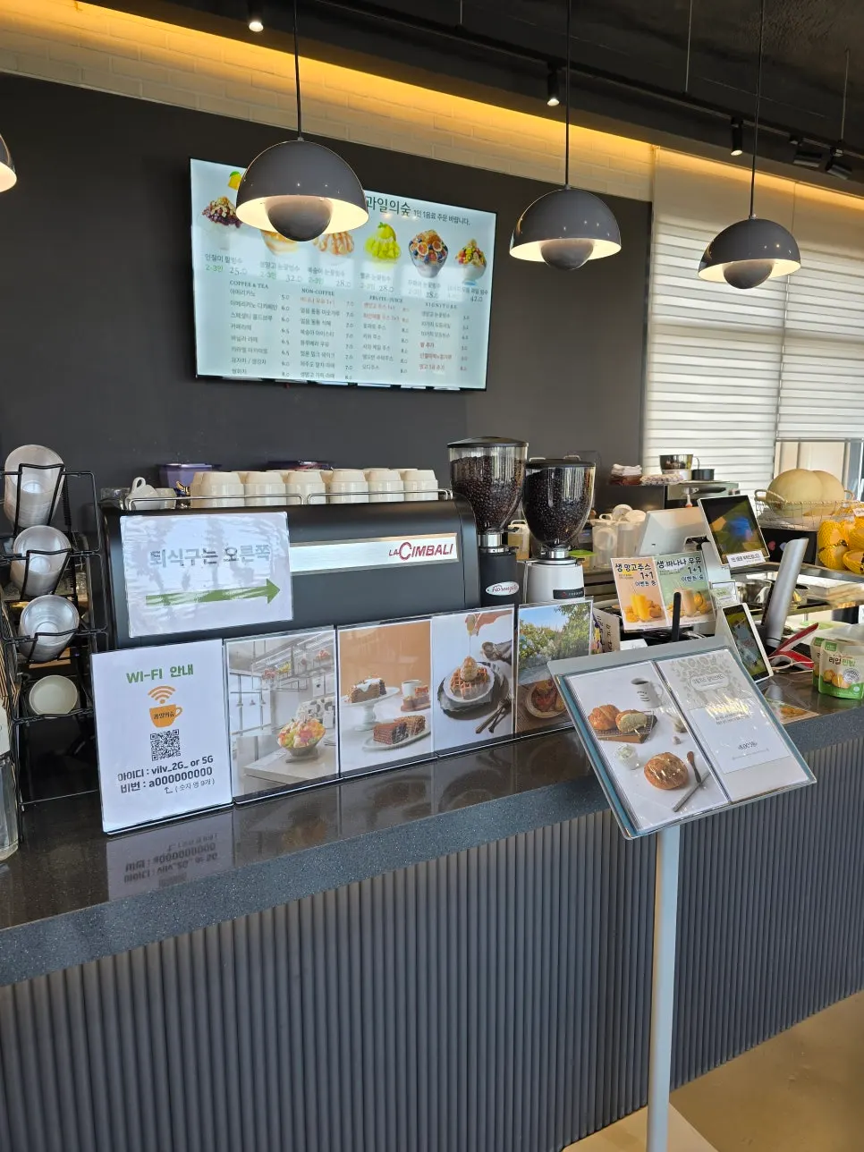 Gray-toned order counter with pendant lighting