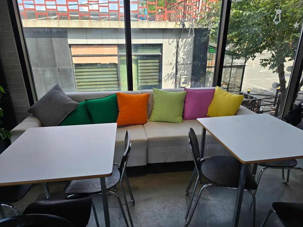 2nd floor seating with floor-to-ceiling windows and round tables