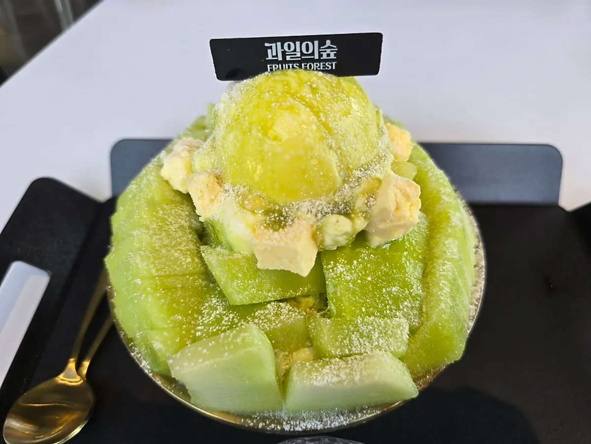 Close-up of melon snow bingsu piled with diced fresh melon
