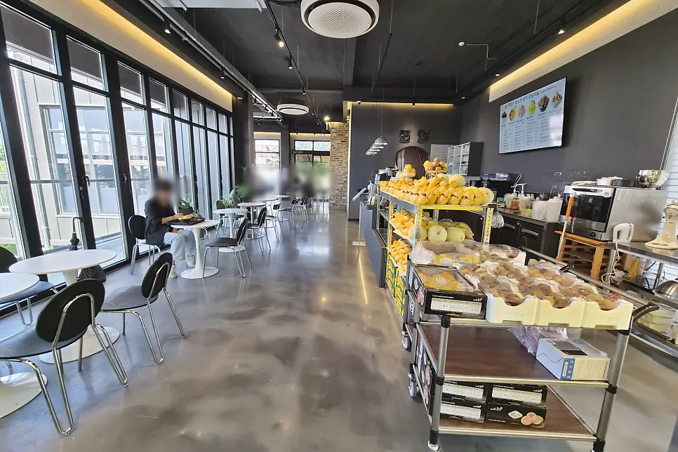 Ground-floor piloti parking space and café entrance