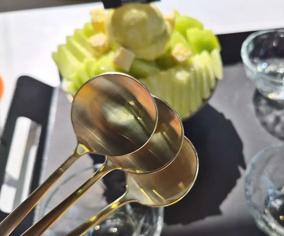 Bingsu spoon resting in the melon bingsu